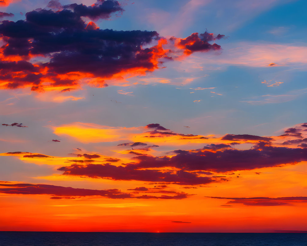 Fiery orange and red sunset over tranquil sea