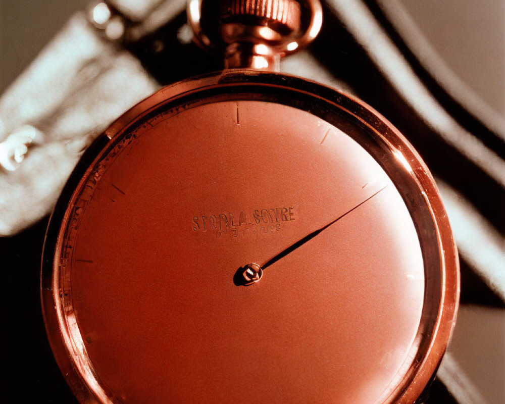 Vintage Red Pocket Watch with Black Hand and Textured Face in Soft Light