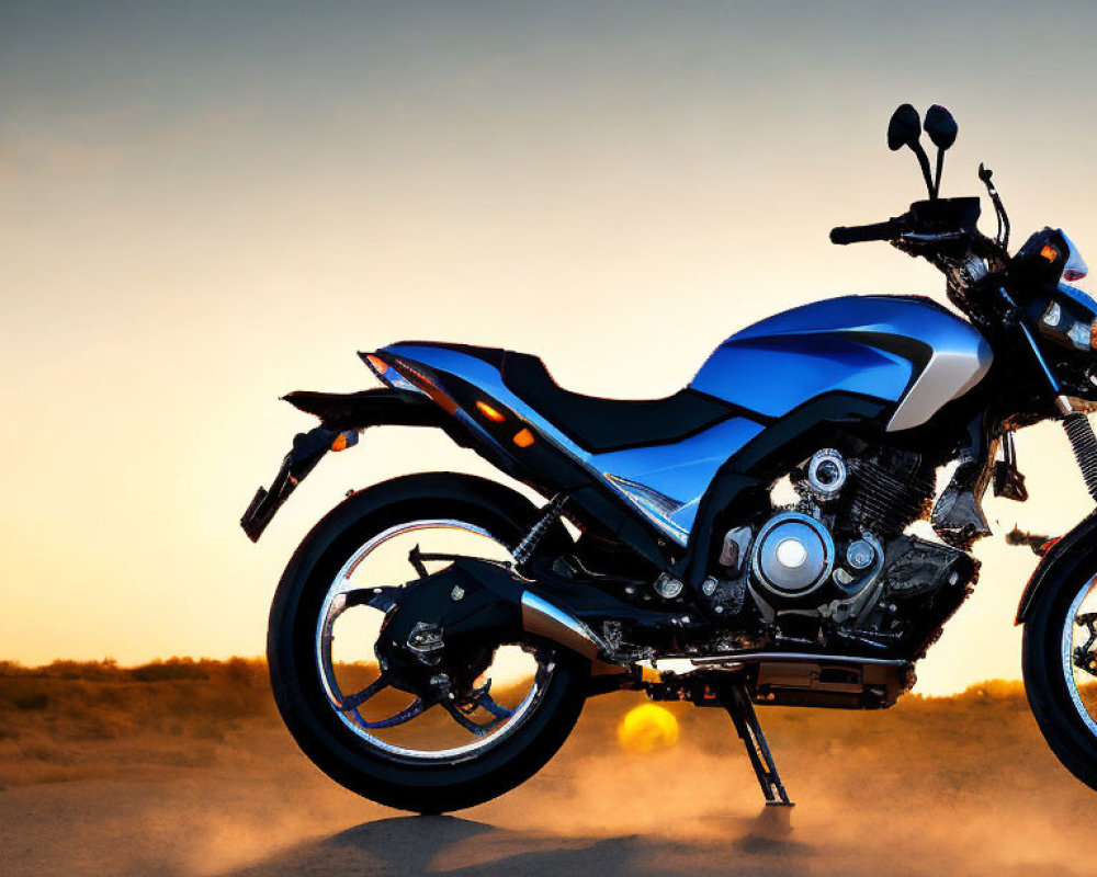 Motorcycle parked on dusty terrain at sunset