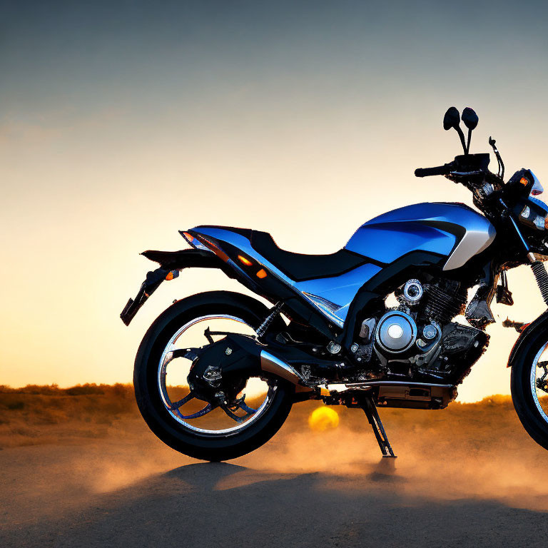 Motorcycle parked on dusty terrain at sunset