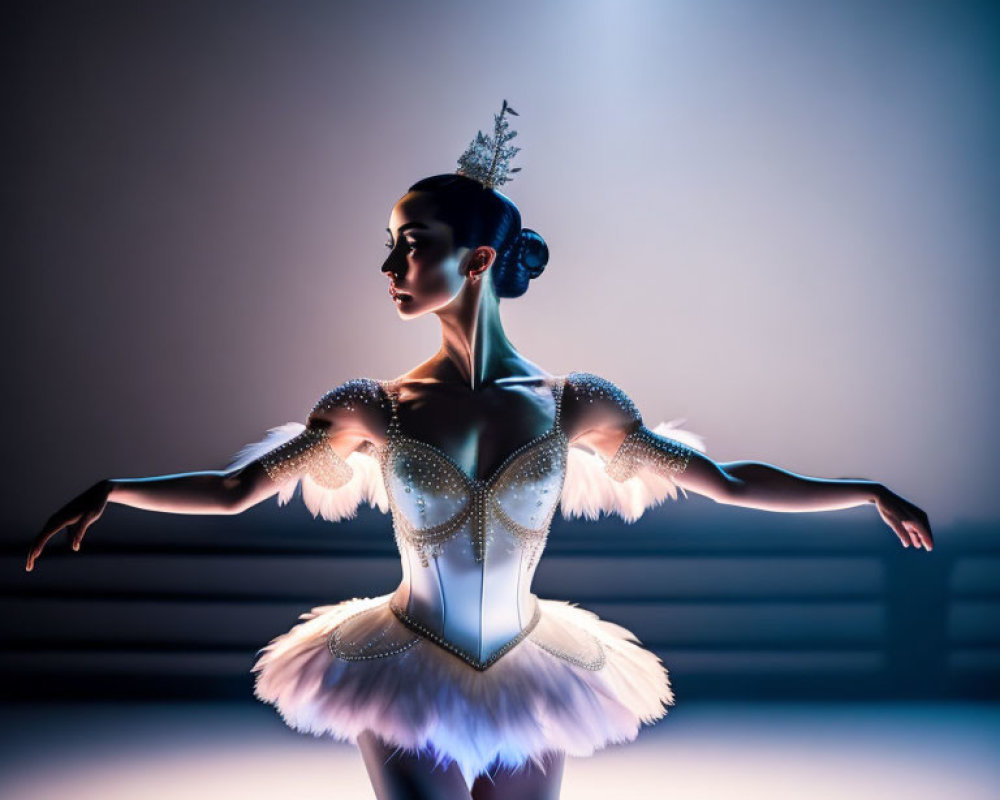 Ballet dancer in white tutu and tiara on pointe with dramatic lighting