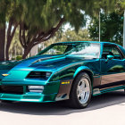 Teal Chevrolet Corvette with T-top and side graphics in sunny day scene