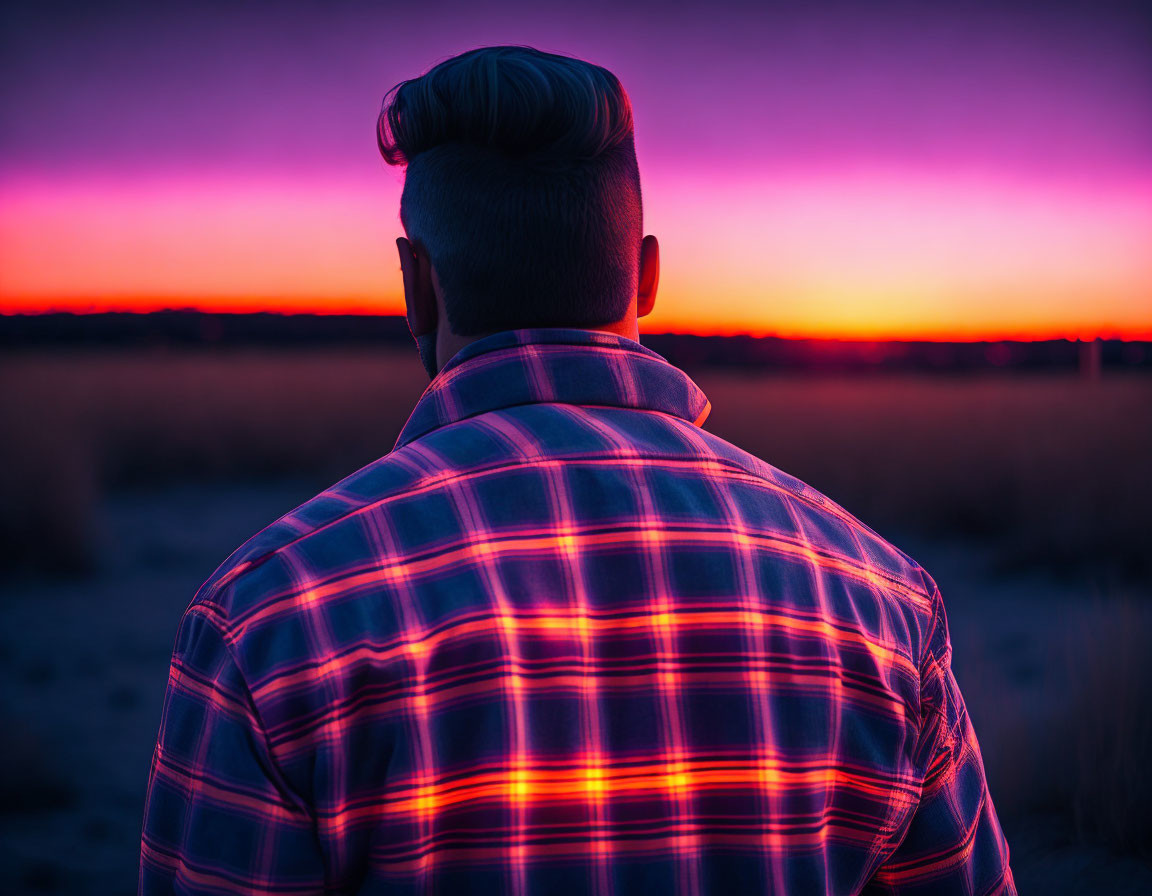 Person with Mohawk Hairstyle Watching Vibrant Sunset