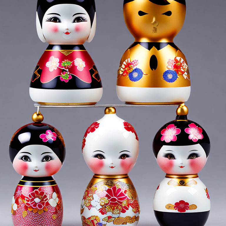 Japanese Kokeshi Dolls with Floral Designs on Gray Background