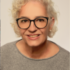 Portrait of Person with Glasses in Warm Splattered Paint on Light Background