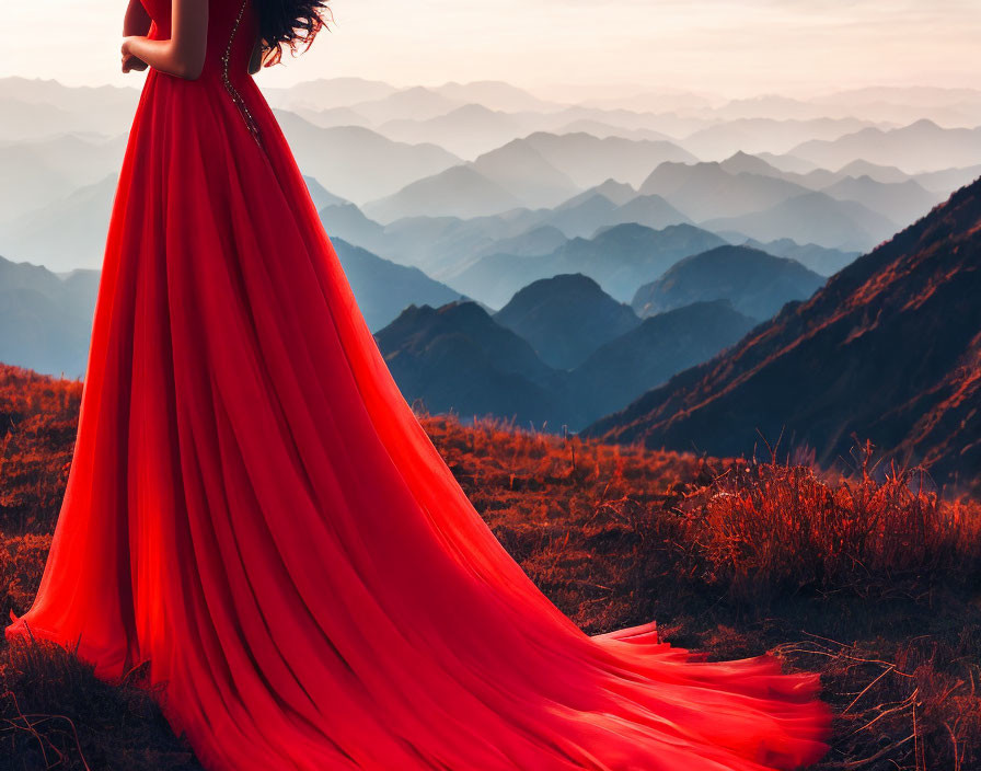 Person in Red Dress Overlooking Misty Mountain Layers at Sunset