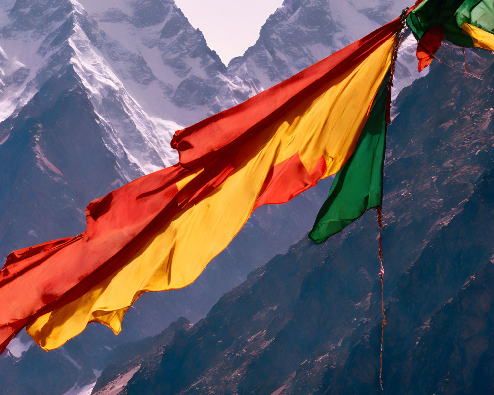 Vibrant prayer flags against snowy mountain peaks