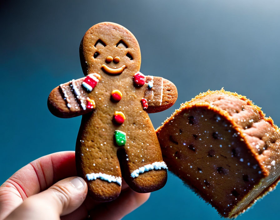 Gingerbread Man Cookie with Bite Taken Out on Blue Background