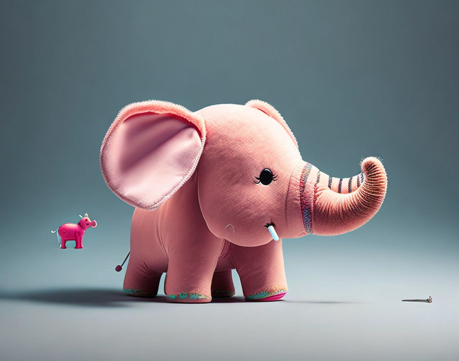 Large Plush Pink Elephant with Colorful Feet and Small Plastic Elephant on Gray Background