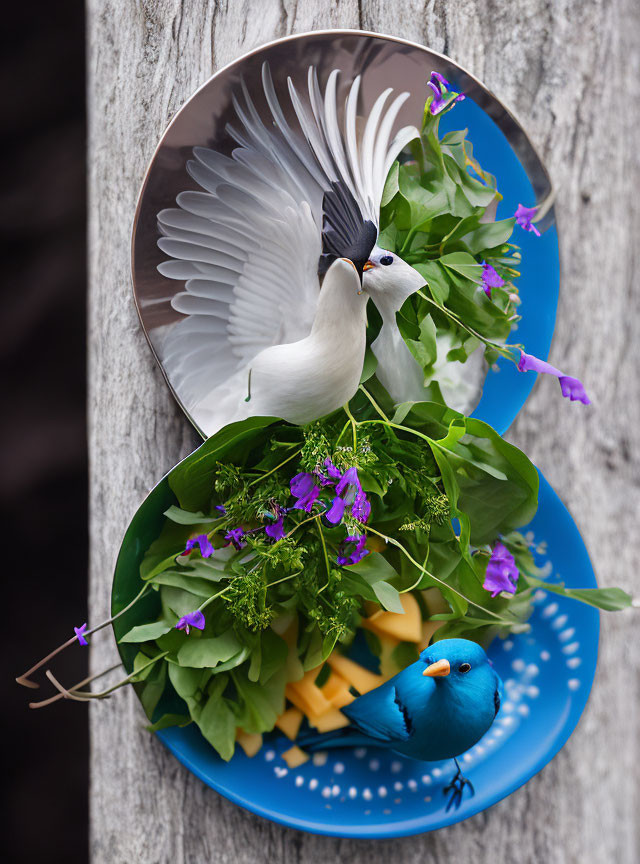 White and blue bird plates with green leaves and purple flowers design.