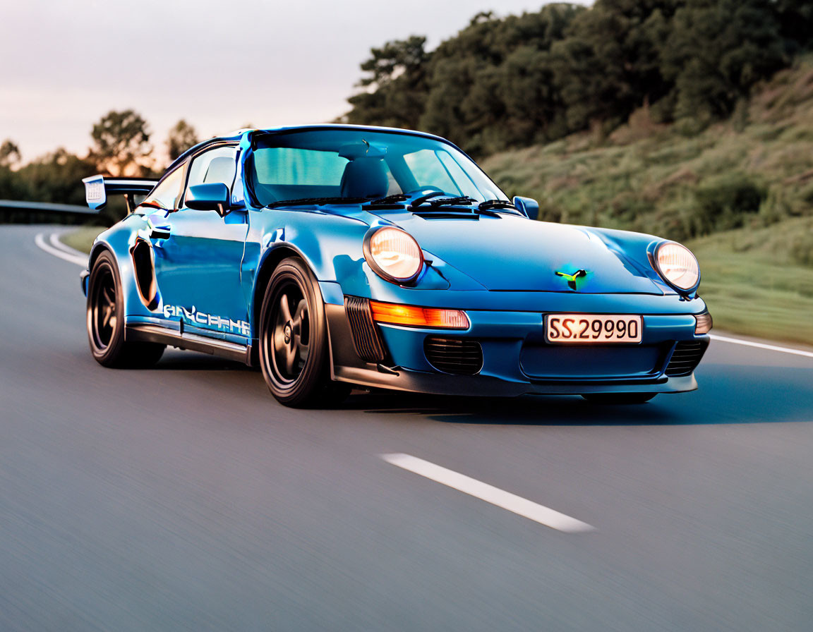 Blue Porsche 911 with Racing Modifications Driving on Road at Dusk