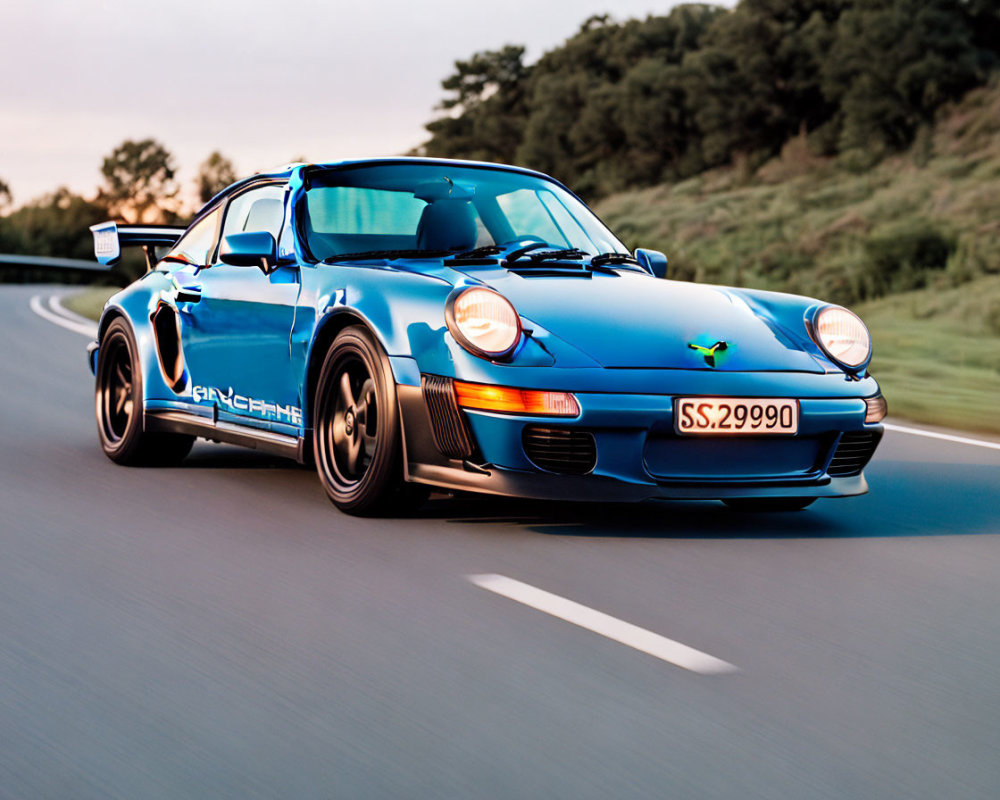 Blue Porsche 911 with Racing Modifications Driving on Road at Dusk