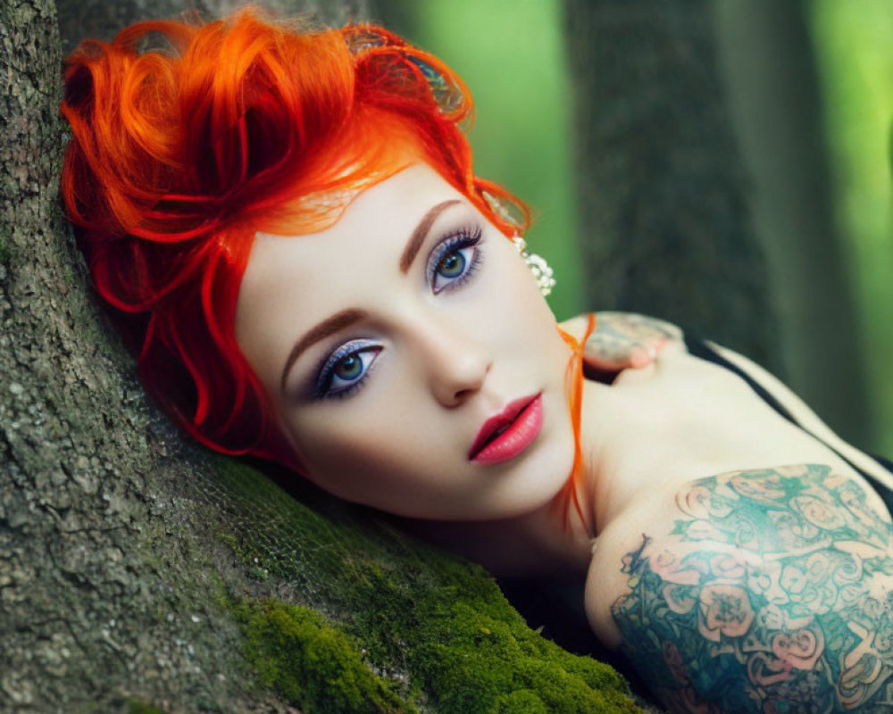 Red-haired woman with tattoos leaning against tree in mossy forest.