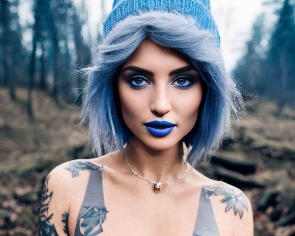 Blue-haired woman with tattoos in beanie against forest backdrop