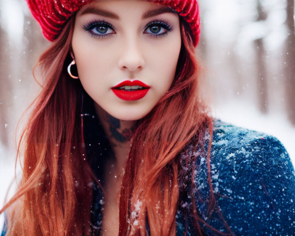 Red-haired woman in blue jacket with snowflakes in snowy setting