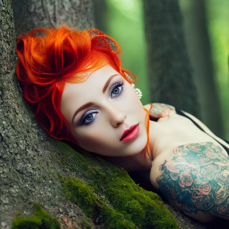 Red-haired woman with tattoos leaning against tree in mossy forest.