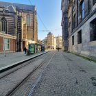 Colorful artwork: Woman with flowing hair in dynamic dress on sunlit street