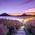 Tranquil watercolor landscape of vibrant sunset over calm lake