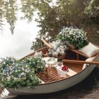 Old Watermill Covered in Pink Roses Beside Calm Waters