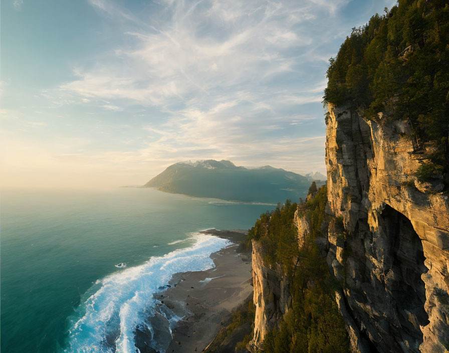 Tranquil coastal sunset scene with rugged cliff and misty beach