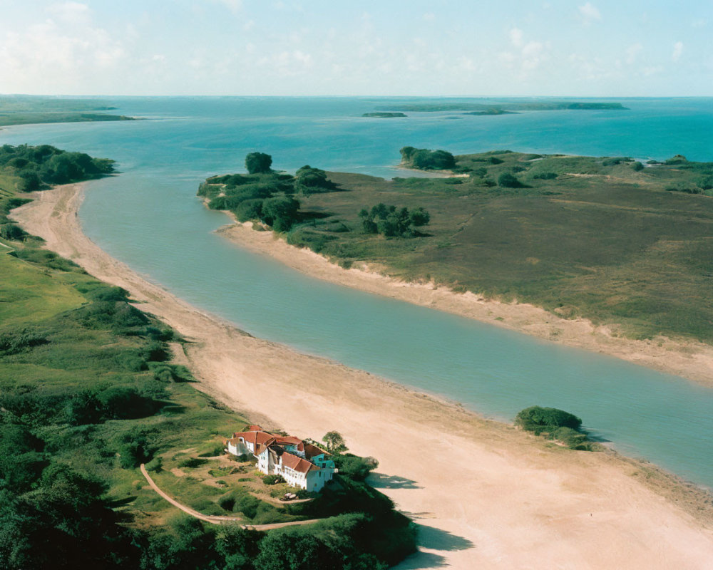 Tranquil river, green landscape, cluster of buildings, vast water body