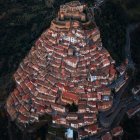 Medieval town with stone towers and warm lights at dusk