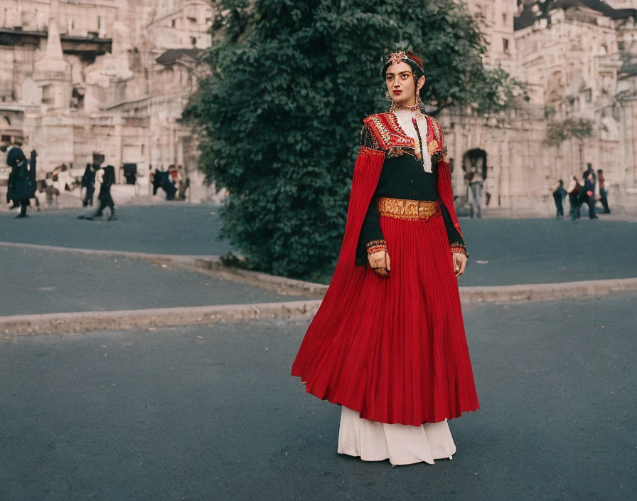 Traditional Red and White Attire Woman with Gold Jewelry in Historic Street Scene