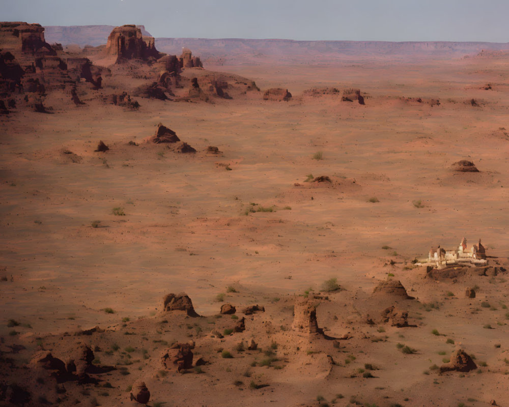 Barren desert scenery with scattered rocks under hazy sky