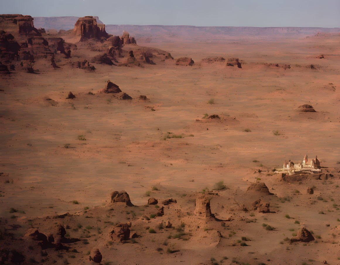 Barren desert scenery with scattered rocks under hazy sky