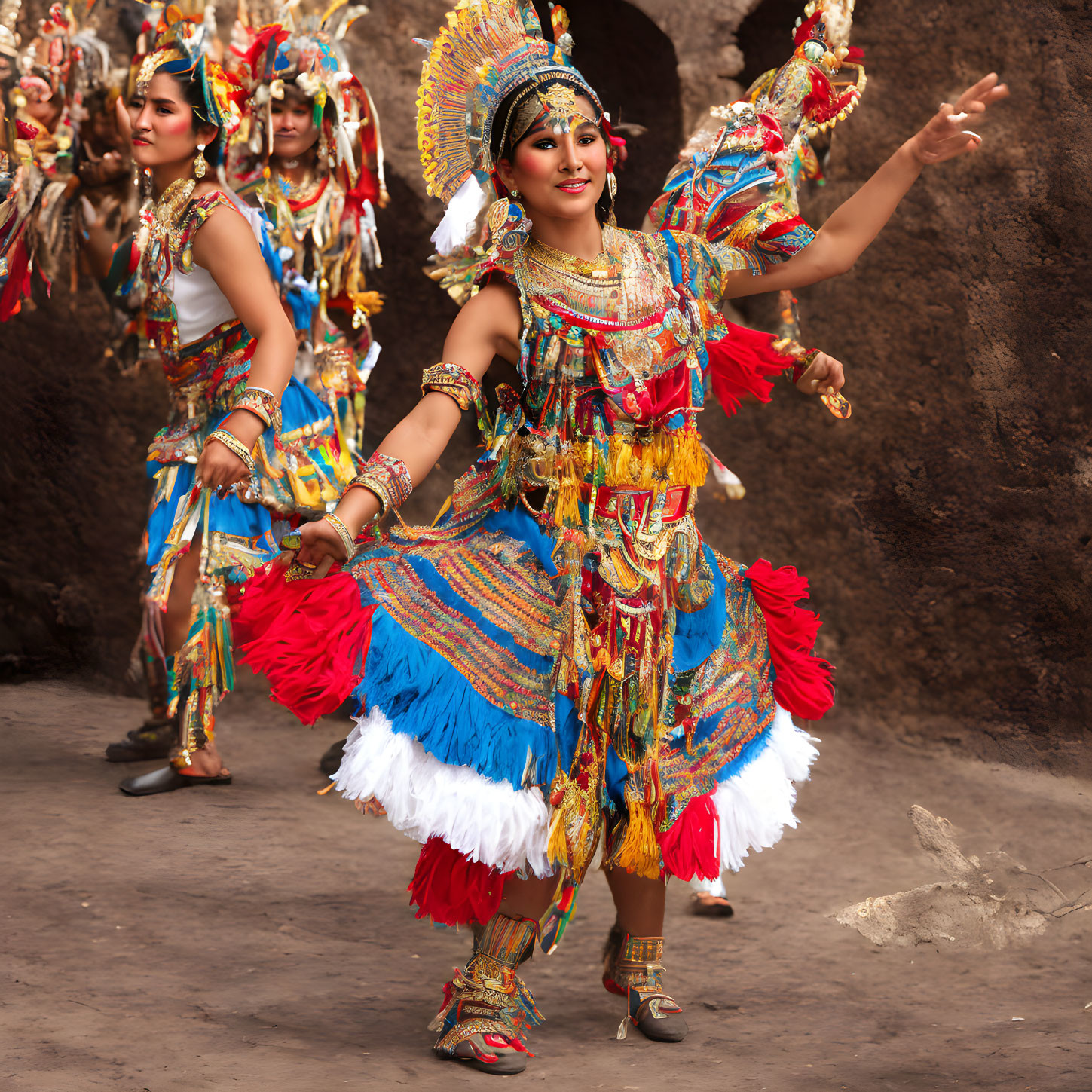 Vibrant traditional dancers in colorful costumes with feathered headdresses performing outdoors