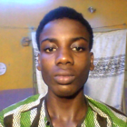 Young man with short haircut in patterned shirt against multicolored background