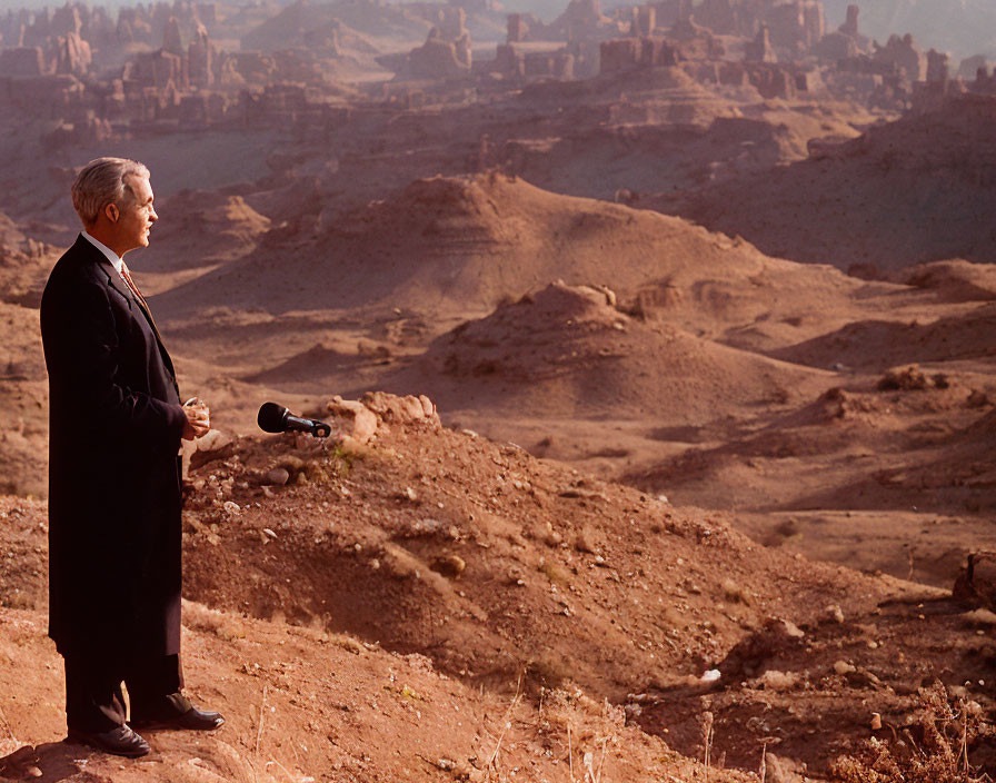 Man in suit with binoculars in desert landscape