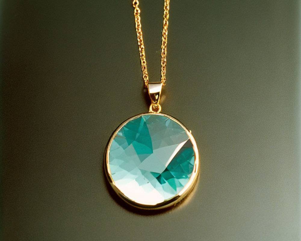 Aquamarine Pendant on Gold Chain Against Dark Background