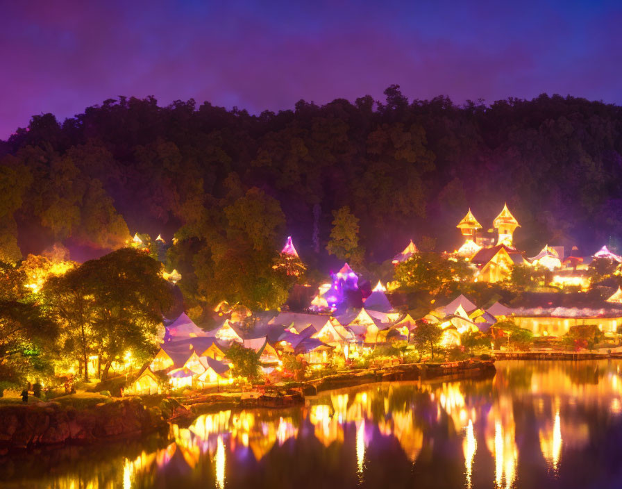 Scenic illuminated village by water at nightfall