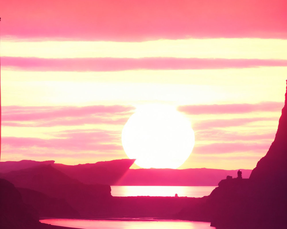 Magenta sunset over mountainous landscape with river