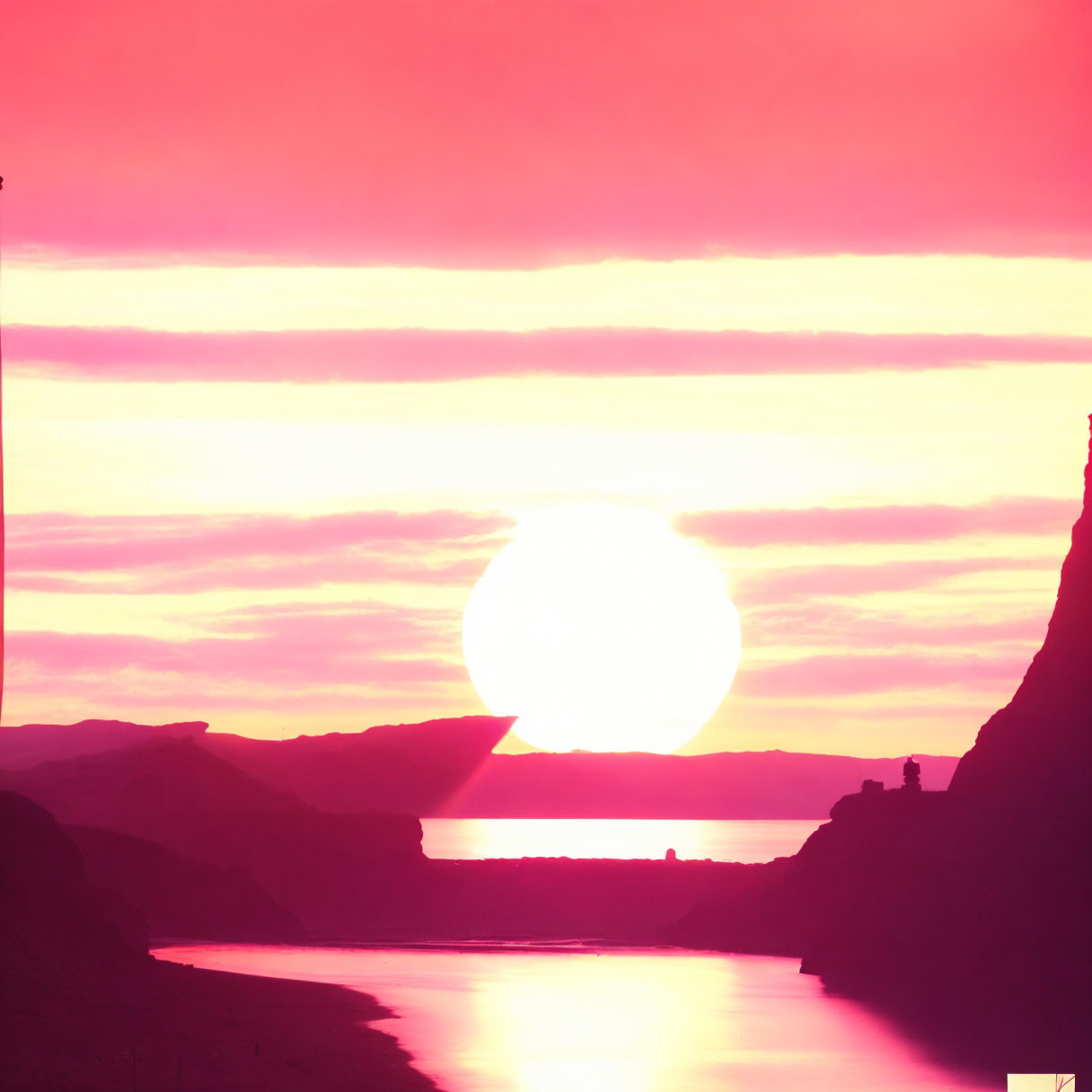 Magenta sunset over mountainous landscape with river