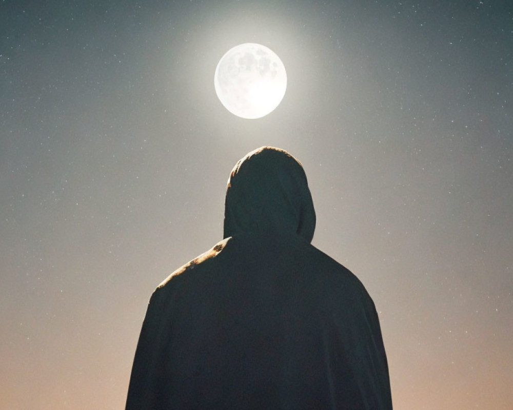 Silhouette of hooded figure under luminous full moon