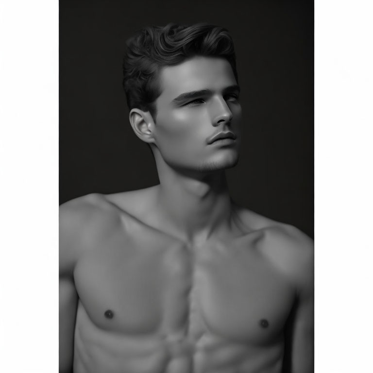 Monochrome portrait of shirtless male model with sculpted features and styled hair