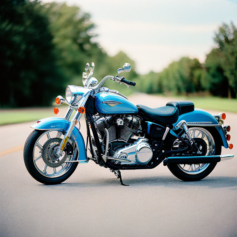 Blue Motorcycle Parked on Tree-Lined Asphalt Road