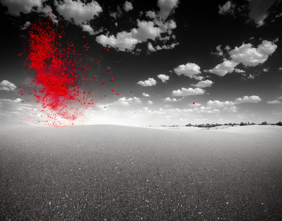 Monochrome desert landscape with red particles contrast.