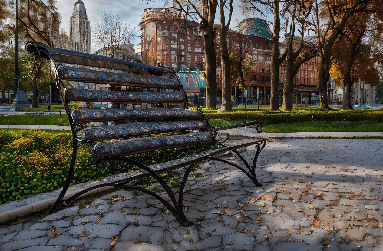 Autumn park scene with empty bench, fallen leaves, and buildings under clear sky