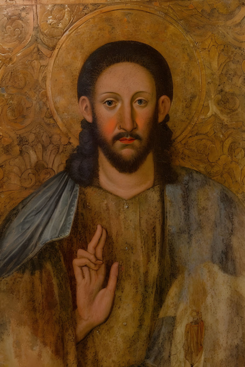 Traditional painting of haloed figure in cloak with sacred heart emblem