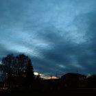 Vivid Twilight Cityscape with Silhouetted Buildings and Birds