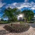 Lush park with colorful flowers, greenery, and cobblestone path