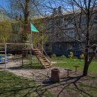 Tranquil backyard scene with blooming trees and playground set