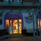 Enchanting candy shop at night with glowing windows and magical entrance