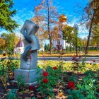 Colorful Bird Sculpture in Vibrant Landscape with Flowers and Pond