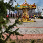 Intricate Carousel in Lush Greenery and Cloudy Sky