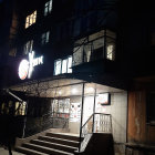 Quaint Blue House Nighttime Scene with Cobblestone Path