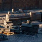 Vintage steam locomotive on snow-covered tracks at golden hour